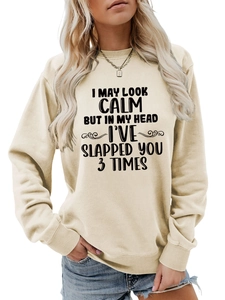 Detail view of beige sweatshirt with black bold humorous text on high-quality cotton fabric