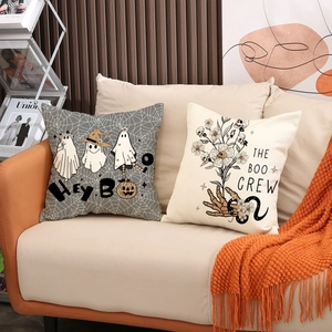 Halloween throw pillows set featuring ghost motifs and Gothic floral skull on beige sofa
