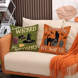 Vintage Halloween throw pillow covers with witch hat and black cat on orange sofa