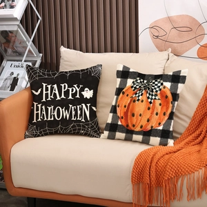 Halloween linen pillow covers with pumpkin and black-white checkered patterns on a sofa