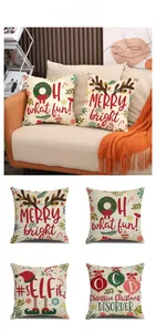 Detail of four Christmas linen pillow covers with festive prints on a cozy orange sofa