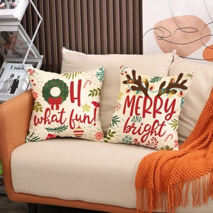 Christmas pillow covers with reindeer and wreath prints on a cozy sofa