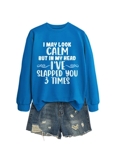 Flat lay of royal blue crewneck sweatshirt with white text and distressed denim shorts