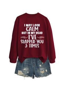 Deep red crewneck sweatshirt with humorous white text print and distressed blue denim shorts