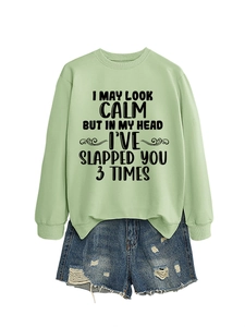 Detailed flat lay of green slogan sweatshirt and ripped denim shorts set with fringe trim