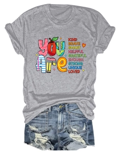 Detail of grey crewneck t-shirt with rainbow motivational text and apple illustration