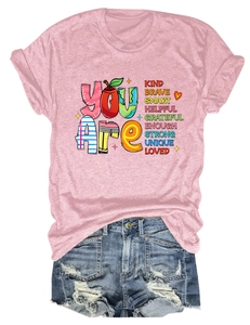 Detail of pink cotton T-shirt with KIND SMART text and distressed blue denim shorts