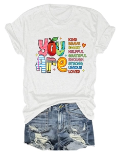 Flat lay of white round neck T-shirt with inspirational text and denim shorts