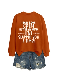 Flat lay of women's orange slogan sweatshirt and distressed blue denim shorts set