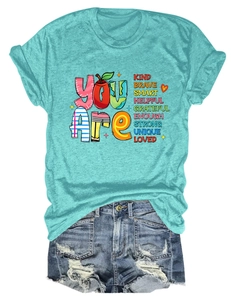 Detail of teal crew neck t-shirt with inspirational text and ripped denim shorts