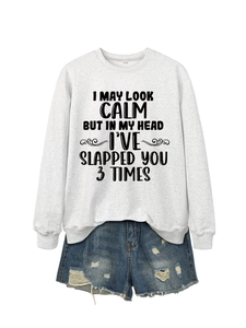 Detail of white cotton sweatshirt with slogan and distressed denim shorts with frayed edges
