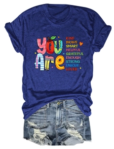 Flat lay of navy t-shirt with You Are Kind Brave lettering and distressed denim shorts