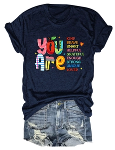 Detailed flat lay of navy t-shirt with You Are Kind Brave slogan and ripped denim shorts