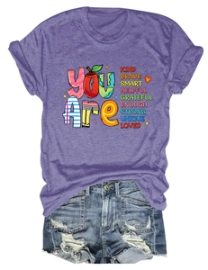 Flat lay detail of heather purple slogan t-shirt paired with distressed blue denim shorts