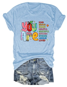 Detail of light blue T-shirt with rainbow print and distressed denim shorts ensemble