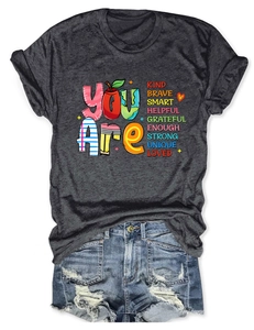 Detail of inspirational 'YOU Are' lettering on a dark grey cotton short sleeve T-shirt