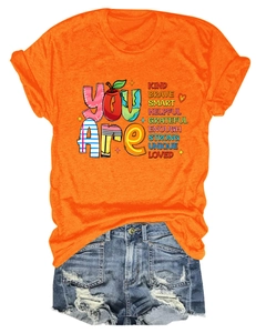 Detailed flat lay of orange letter print T-shirt and distressed denim shorts set