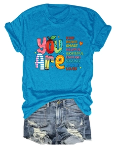 Detail of inspirational 'YOU ARE KIND BRAVE' typography printed on casual sky blue cotton t-shirt