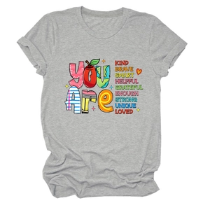 Detail of grey crewneck t-shirt with You Are Kind Brave slogan and rolled-up sleeves