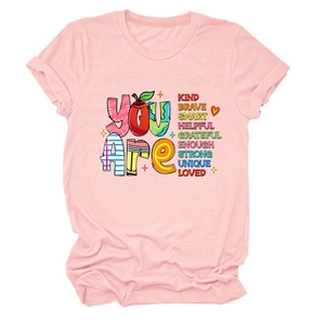Close-up of pink round neck T-shirt featuring 'YOU ARE' inspirational screen print