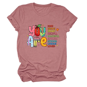 Close-up of inspirational typography and artistic graphics on pink women's t-shirt