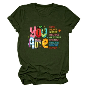 Flat lay of army green crew neck t-shirt with colorful Kind Brave inspirational graphics