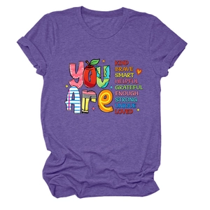 Close-up of purple t-shirt fabric texture with colorful YOU ARE educational print