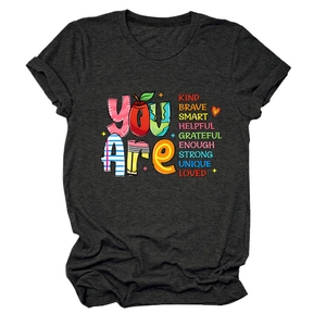 Close-up of the teacher-themed inspirational colorful text print on a dark grey t-shirt