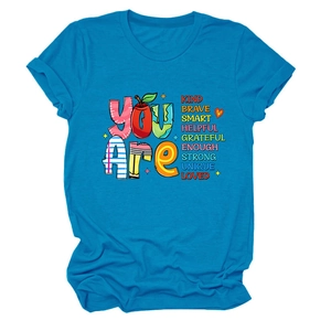 Detail of bright blue cotton t-shirt featuring colorful KIND BRAVE SMART typography print