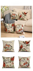 Close-up of four Christmas linen pillowcases with bird motifs and festive greetings
