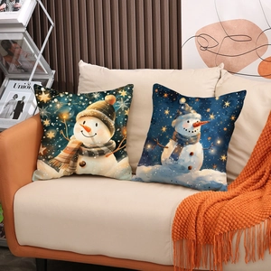 Christmas snowman decorative linen throw pillows set of two on a beige leather sofa