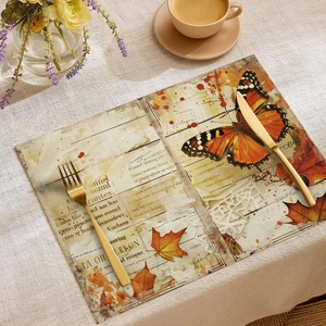 Macro view of vintage linen placemat with autumn maple leaf and butterfly print design