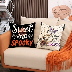 Halloween throw pillow covers set with spooky prints on sofa with orange blanket