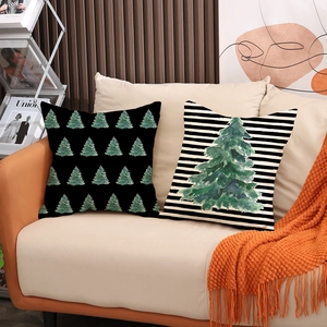 Set of two Christmas pillow covers with tree patterns and stripes on a beige sofa
