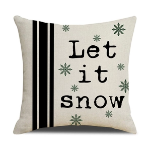 Christmas cushion cover featuring Let it snow text and green snowflakes on linen fabric