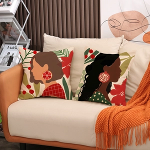 Artistic linen pillow covers featuring abstract female portraits and floral motifs on sofa