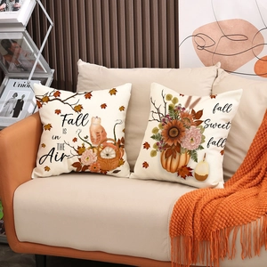 Fall pumpkin and sunflower pillow covers set on sofa with cozy orange knitted throw