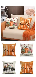 Close-up of four autumn pumpkin pillow covers with watercolor designs and rustic textures