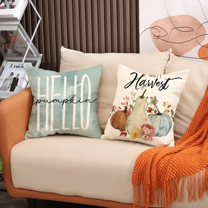 Autumn throw pillow covers with pumpkin designs on a cozy sofa for fall home decoration