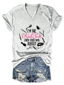 Lay-flat detail of a V-neck T-shirt with 'I'm the Nail Tech' text and denim shorts
