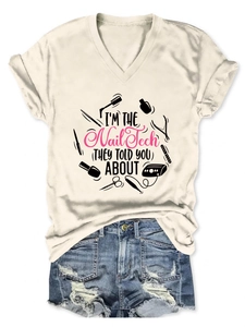 Flat lay of a beige V-neck Nail Tech T-shirt paired with distressed blue denim shorts