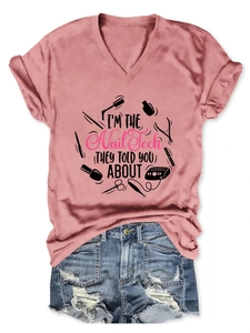 Flat lay of pink V-neck Nail Tech slogan T-shirt with distressed denim shorts