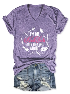 Flat lay of purple V-neck nail tech graphic tee with ripped denim shorts set