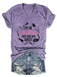 Detail of V-neck heather purple T-shirt with I'm the Nail Tech print and denim shorts