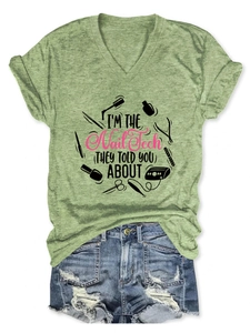 Flat lay detail of green V-neck Nail Tech T-shirt paired with distressed denim shorts
