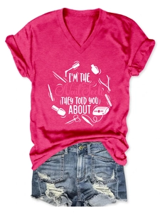 Detailed close-up of rose red V-neck T-shirt with white nail technician graphic and text