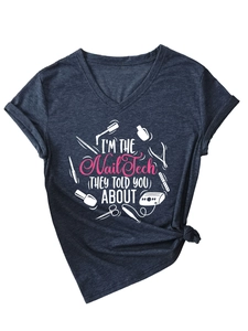 Detail of V-neck cotton T-shirt with 'I'M THE Nail Tech' slogan and nail art tool graphics