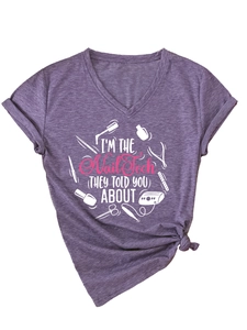 Detail of purple heather V-neck tee with I'M THE Nail Tech print and knotted hem design
