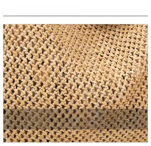 Close-up detail of high-quality woven straw fabric on a minimalist shoulder tote bag