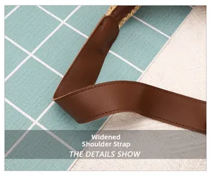 Close-up of brown wide PU leather shoulder strap with stitching on woven tote bag